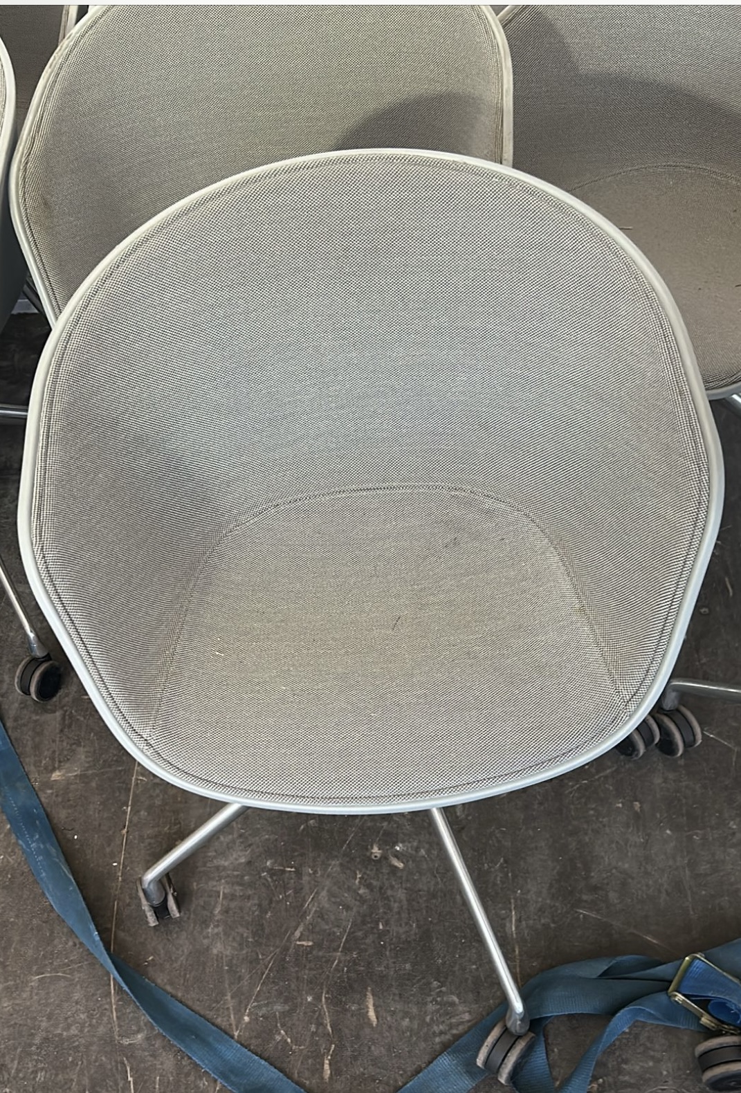 Hay AAC26 About A Chair Grey Tweed fabric with White shell situated on chrome 4 star wheeled base